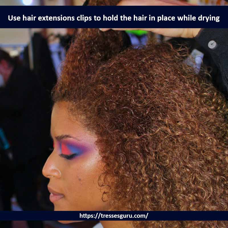 Use hair extensions clips to hold the hair in place while drying 