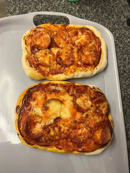 Homemade pepperoni pizza and cheesy garlic bread